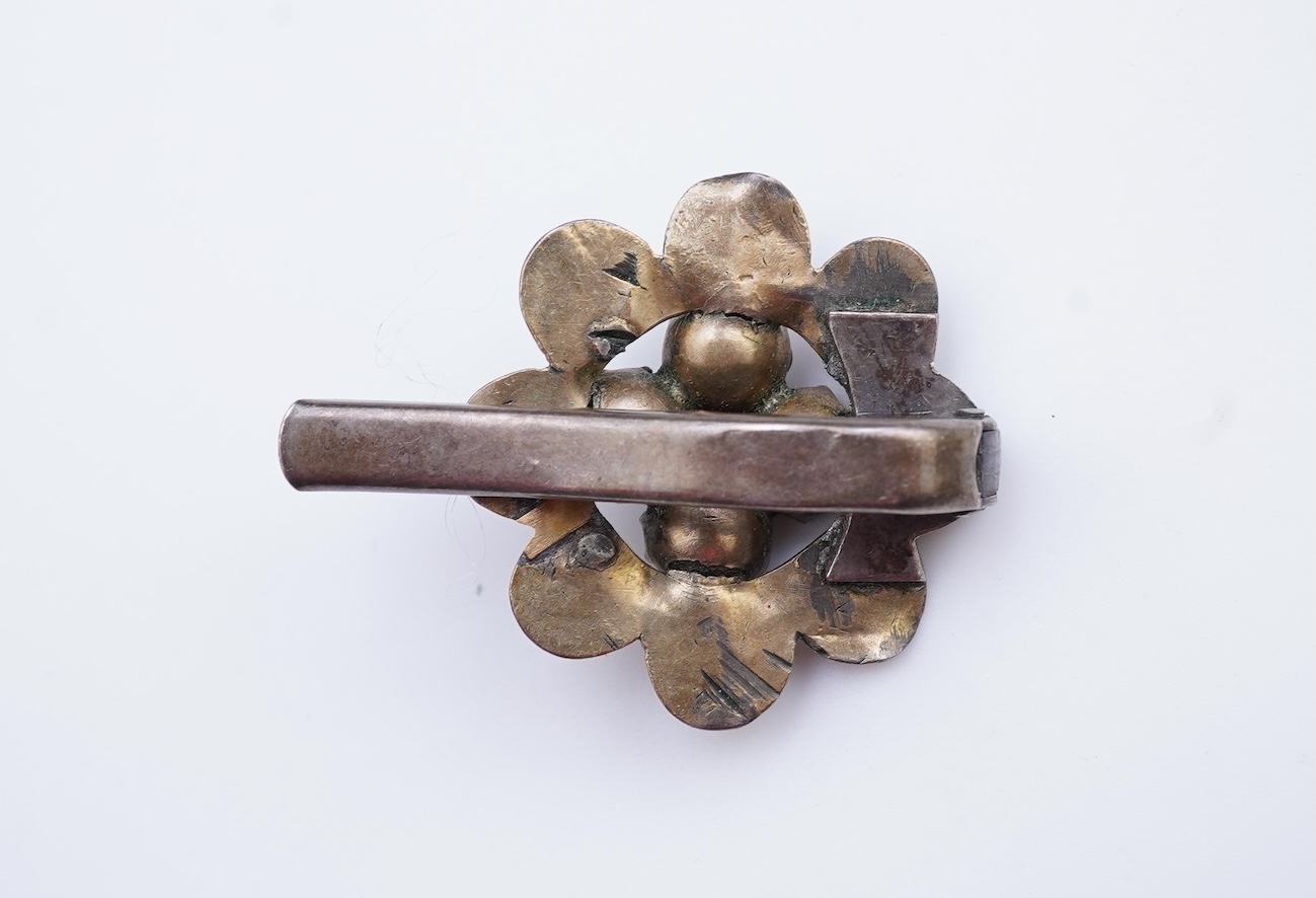 A suite of garnet and paste jewellery, comprising: a brooch, 5cm diameter; a bangle, inner circumference 16cm; two rings, sizes I and M; a pair of earrings, and a single earring, each set with rose-cut garnets; and a pai
